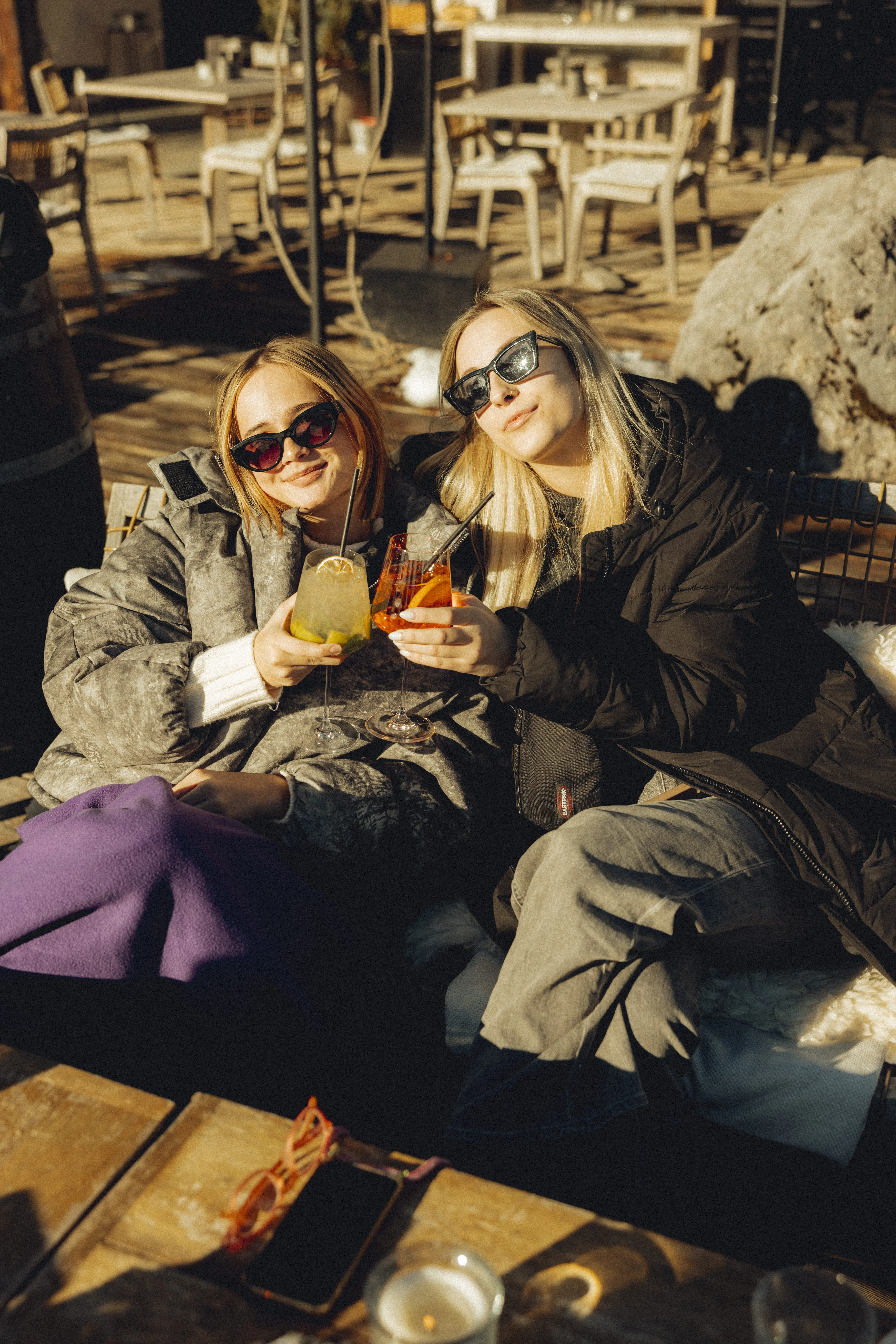 Women enjoying drinks in the winter sun